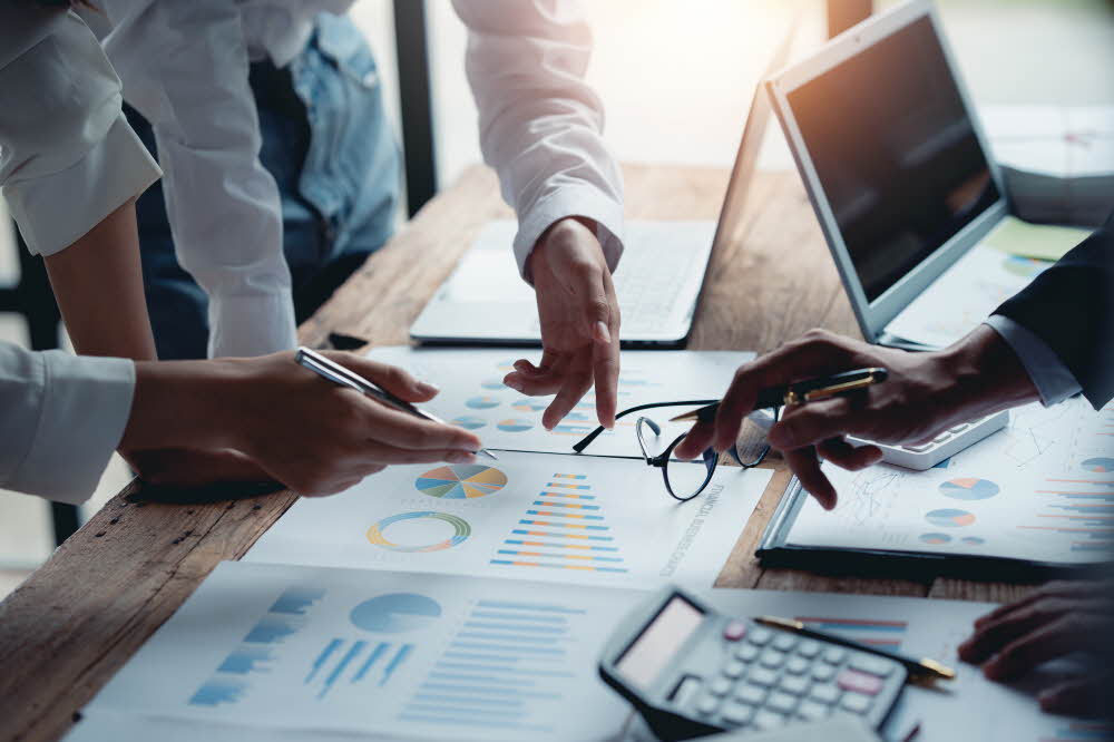 Business team meeting and presentation discuss and analyze financial and accounting chart and graph. Marketing new business idea.
